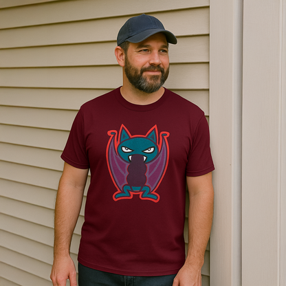 Man wearing Nocturnal Fury maroon tee shirt leaning against a wall.